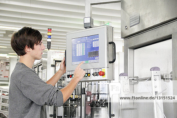 Man using control panel in brewery