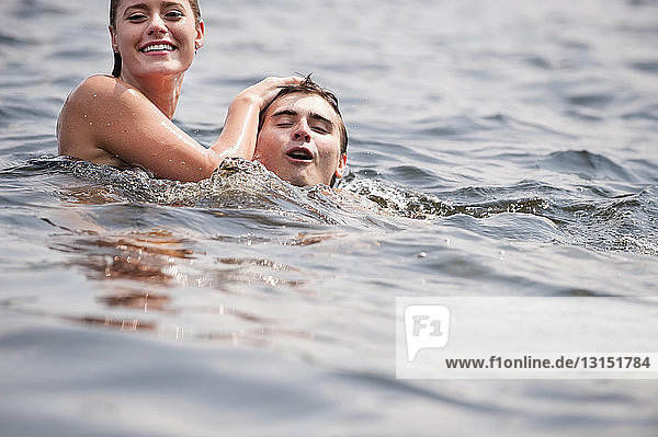 Young couple swimming in lake