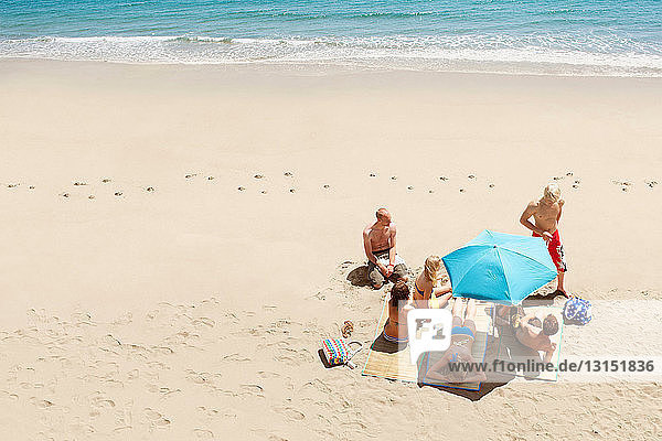 Group of people sunbathing on beach