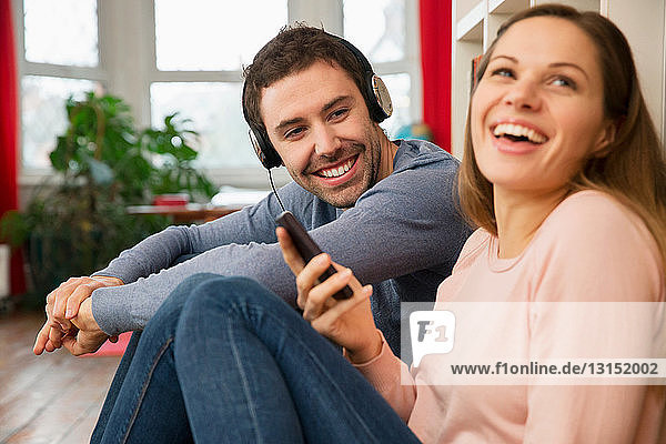 Young couple laughing  man wearing headphones