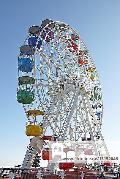 Empty ferris wheel against blue sky