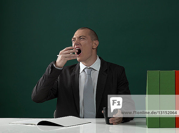 Business man yawning
