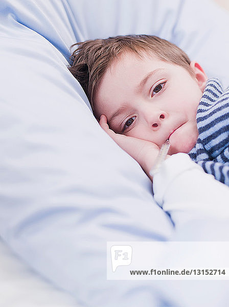 boy in bed looking at viewer