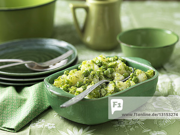 Potatoes and peas salad with minted butter