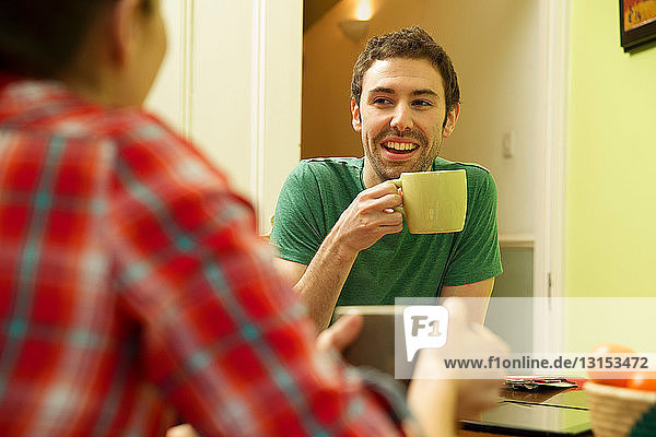 Young couple at breakfast  man holding coffee cup