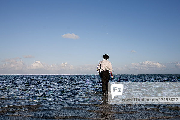 Businessman standing in sea