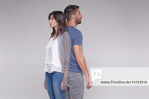 Man standing back to back with transparent woman
