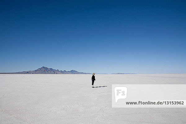 Woman standing on the Bonneville Salt Flats  Tooele County  Utah  USA