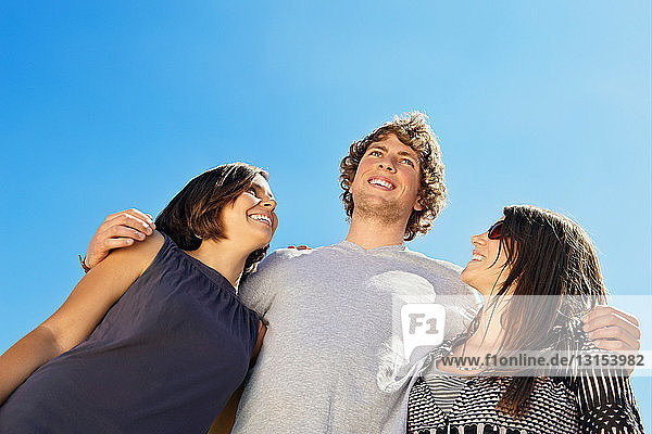 Portrait of three people against sky