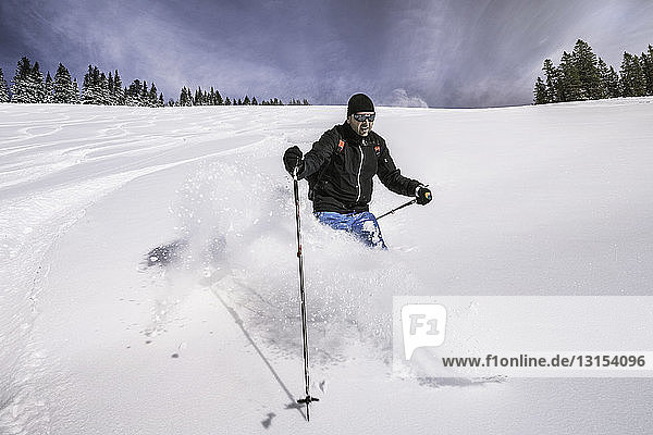 Mann beim Skifahren auf einer verschneiten Piste  Spitzingsee  Deutschland