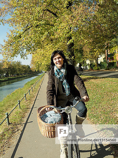 Woman riding bicycle in Autumn