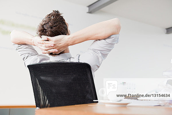 Man leaning back in chair