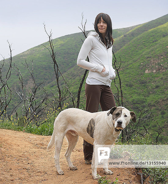 Dog and woman standing on path