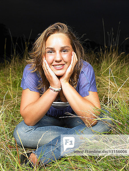 Girl sitting in a field  by night
