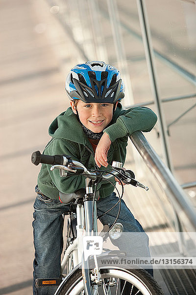 Boy sitting on bicycle in city tunnel