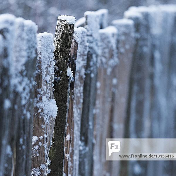 Snow covered wooden barrier