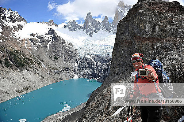 Woman takes her picture in front of Laguna Sucia in Los Glaciares National Park  El Chalten  Argentina