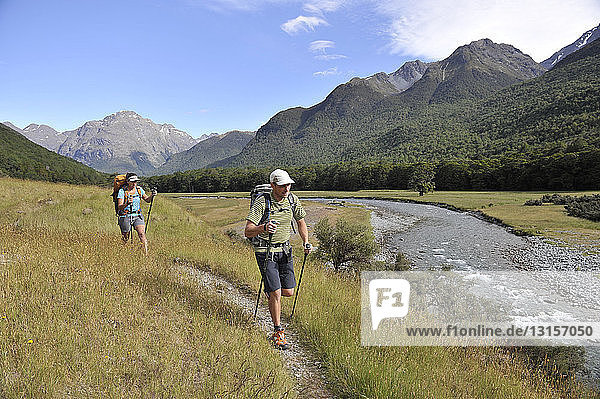 Couple hiking by river  New Zealand