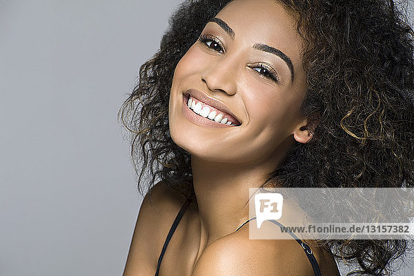 Studio portrait of beautiful happy young woman