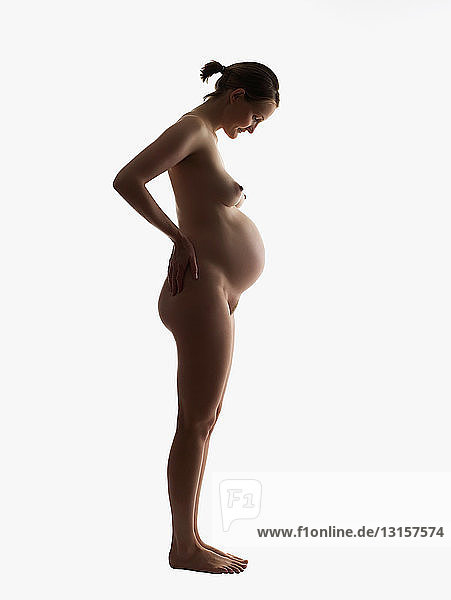 Silhouette of nude pregnant woman