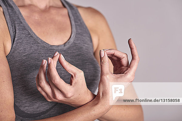 Cropped shot of woman meditating with fingers together