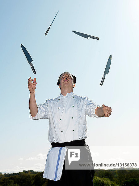 Chef juggling with knives