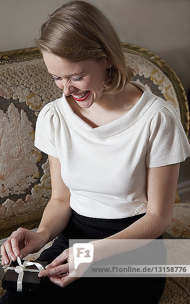 Close up of woman opening gift