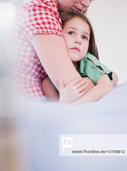 mother holding daughter in her arms
