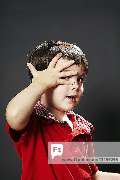 Porträt eines Jungen mit Hand im Gesicht