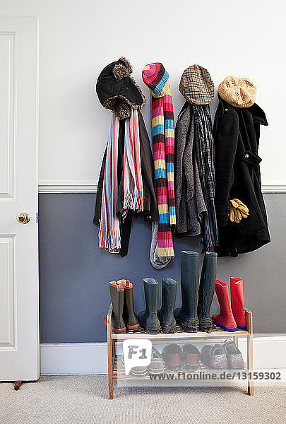 Coats and hats hanging on wall in hallway