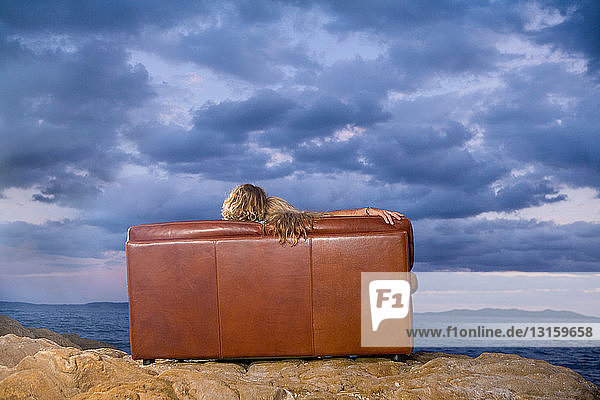Paar auf Couch schaut aufs Meer