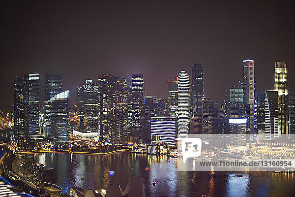 View of skyscrapers on waterfront at night  Singapore
