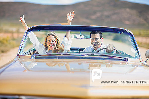 Junges Paar am Steuer eines Cabriolets