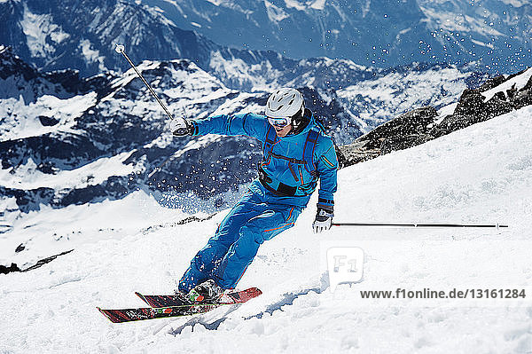Male skier speeding down mountain