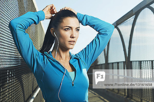 Woman wearing sports clothes preparing to run