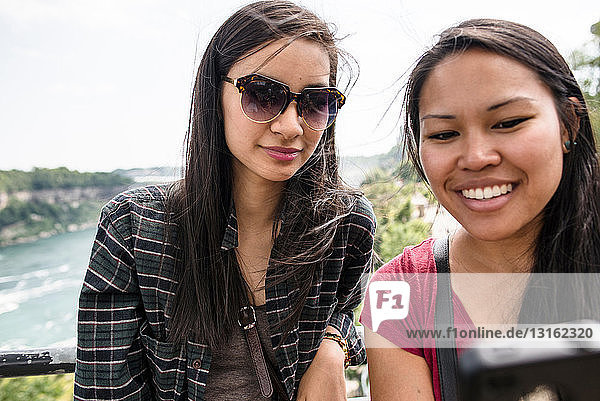 Young women taking self portrait photograph at Niagara Falls