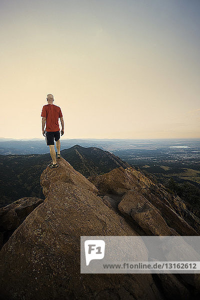 Mature male hiker standing on top of rock formation  Boulder  Colorado  USA