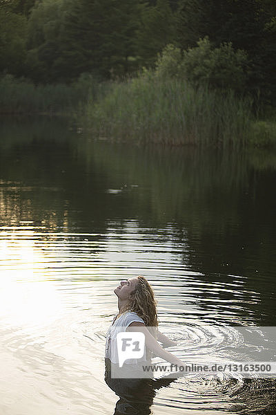 Teenage girl enjoying river in the evening