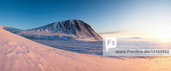 Mountains and river in snowy landscape