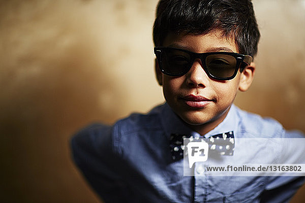 Boy wearing sunglasses and bow tie