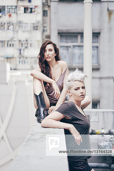 Portrait of two young women on apartment rooftop