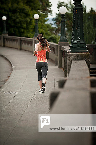 Woman running on city street