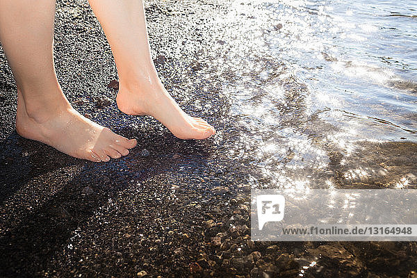 Woman's feet paddling in water