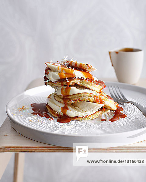 Plate of coconut pancakes with cream