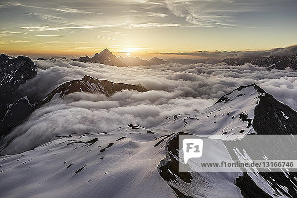 View of Bavarian Alps as sun rises above the clouds  Oberstdorf  Bavaria  Germany