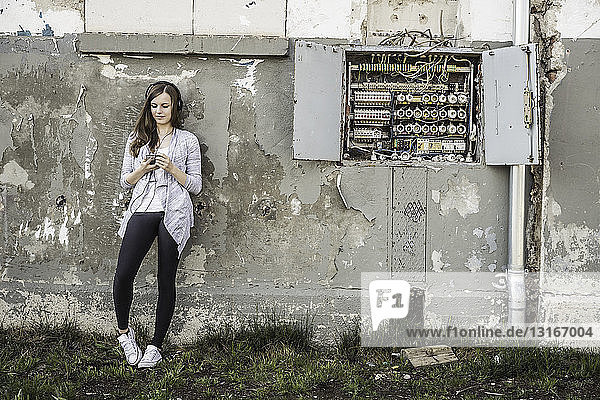 Teenage girl hanging out at abandoned building
