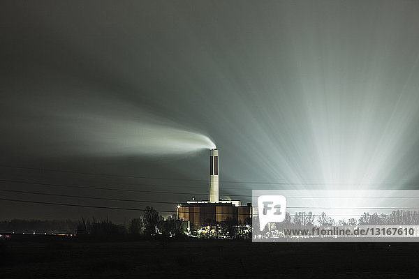Ansicht von Kraftwerk und Schornstein bei Nacht, Bremerhaven, Deutschland