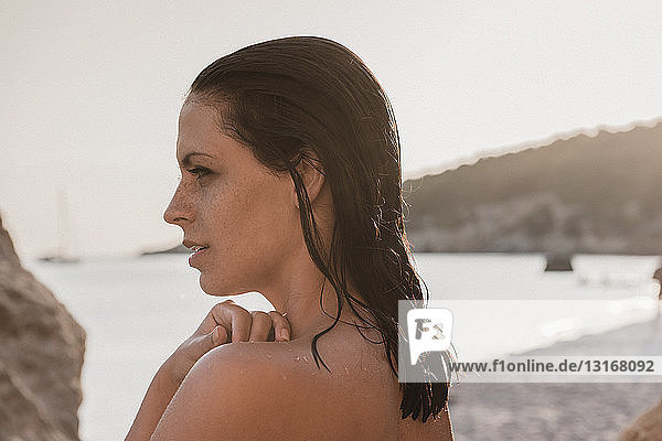 Bare shouldered young woman on beach  Menorca  Balearic Islands  Spain