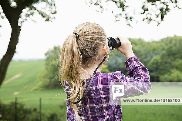 Girl using binoculars