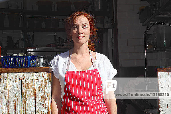 Woman in apron working outdoors